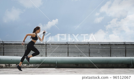 Woman athlete doing running and lunge exercise workout on rooftop. 96512067