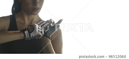 Woman put fitness gloves  for exercise at gym. 96512068
