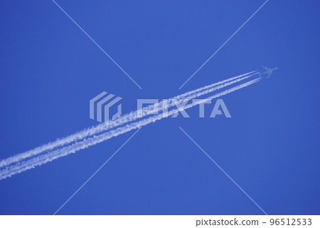 Jumbo jet flying in the blue sky and contrail 96512533