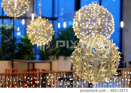 Ornaments and lights on the decorated Christmas tree. 96513973