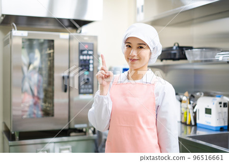 Young female cook (pointing pose) 96516661