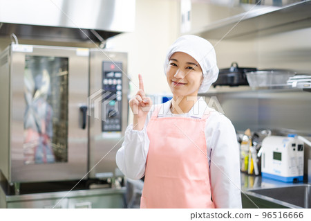 Young female cook (pointing pose) 96516666