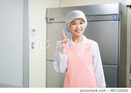 Young female cook (pointing pose) Young female cook (pointing pose) 96516669