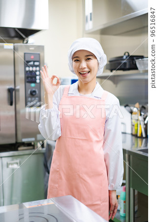 Young female cook (OK sign) 96516847