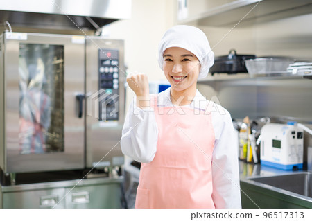 Young female cook (guts pose) 96517313