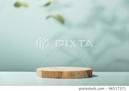 Wood slice podium with eucalyptus leaves on blue background for cosmetic product mockup Wood slice podium with eucalyptus leaves on blue background for cosmetic product mockup 96517371