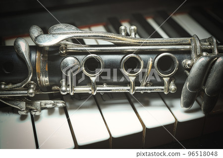 An antique clarinet leaning piano 96518048