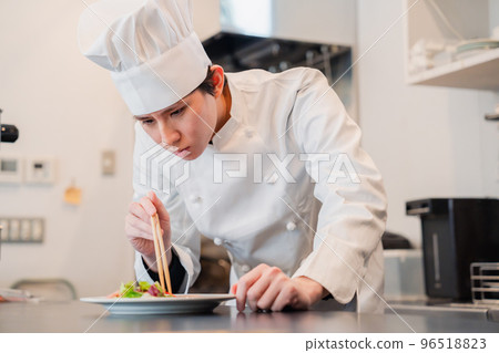 Male chef serving food 96518823
