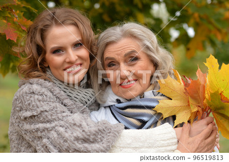 Portrait of an elderly woman with her daughter in autumn. Portrait of an elderly woman with her daughter in autumn. 96519813