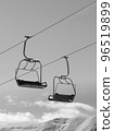 Black and white chair lifts and snowy winter high mountains 96519899
