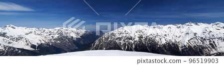 Panorama of high snow-capped mountain peaks and beautiful sky with clouds at sunny day. Panorama of high snow-capped mountain peaks and beautiful sky with clouds at sunny day. 96519903