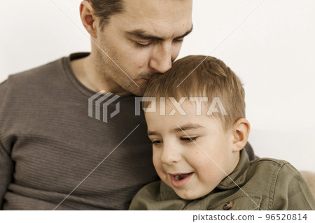 Portrait of father and son. Dad loves his boy. Positive family relationship. Young attractive man and his little kid spending time together. Respect and support, be a good example. Father's Day. Portrait of father and son. Dad loves his boy. Positive family relationship. Young attractive man and his little kid spending time together. Respect and support, be a good example. Father's Day. 96520814