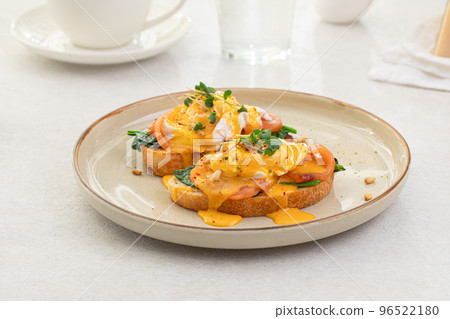 Portion of eggs benedict toast with salmon Portion of eggs benedict toast with salmon 96522180