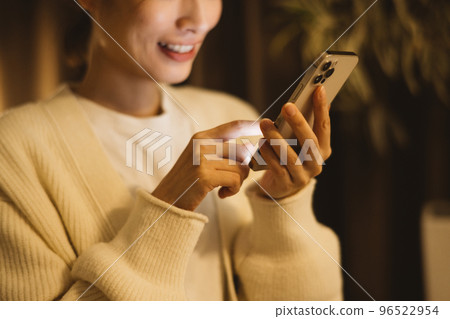 woman looking at smartphone at night 96522954