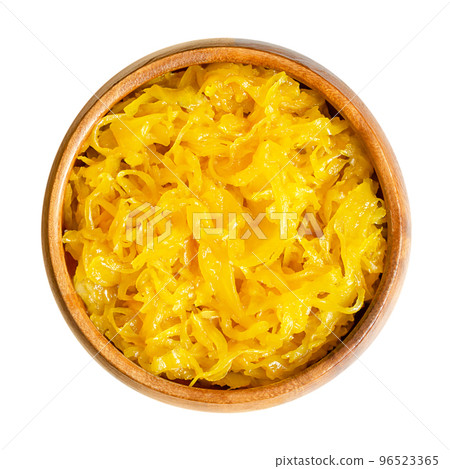 Sweet golden curry mango sauerkraut, in a wooden bowl. Finely cut cabbage, fermented by lactic acid bacteria, with added mango puree and mild curry powder. Used as side dish with a distinctive flavor. Sweet golden curry mango sauerkraut, in a wooden bowl. Finely cut cabbage, fermented by lactic acid bacteria, with added mango puree and mild curry powder. Used as side dish with a distinctive flavor. 96523365