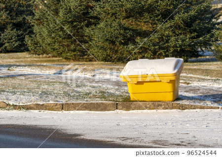 Yellow plastic box with salt or sand on the street Yellow plastic box with salt or sand on the street 96524544