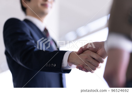Two businessmen shaking hands 96524692