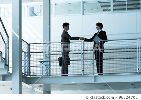 Two businessmen shaking hands 96524703