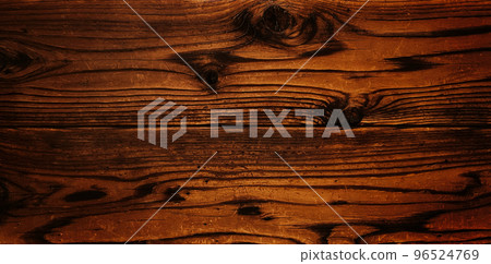 Horizontal background image of a worn and scratched plank of dark brown wood grain Horizontal background image of a worn and scratched plank of dark brown wood grain 96524769
