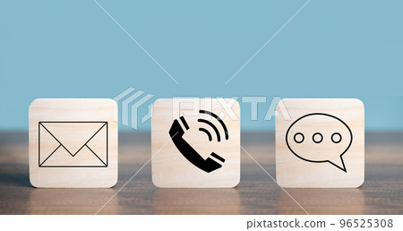 Customer Contact Us Service icons  with Mail, Email, Telephone, Messages on the square wooden  put on the desk. 96525308