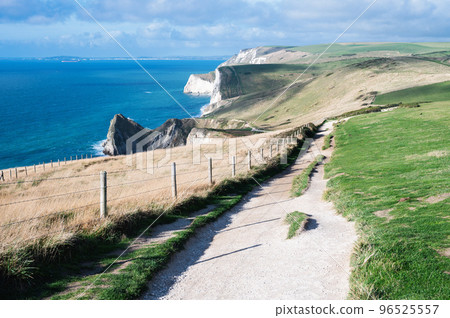 Beautiful views of nature on way to Durdle door in Lulworth, Dorset, United Kingdom. Part of Jurassic Coast World Heritage Site, view of stone formations and sea, selective focus Beautiful views of nature on way to Durdle door in Lulworth, Dorset, United Kingdom. Part of Jurassic Coast World Heritage Site, view of stone formations and sea, selective focus 96525557