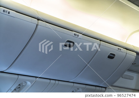 Luggage overhead in the cabin No.59 60 61 in airplane Luggage overhead in the cabin No.59 60 61 in airplane 96527474