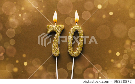 Number 70 seventy candle on bokeh background Number 70 seventy candle on bokeh background 96528872