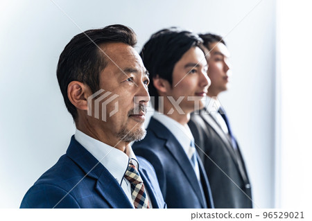 Businessmen of a wide range of generations looking into the distance 96529021