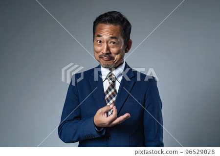 Suspicious businessman showing money hand sign 96529028