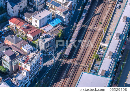 Tokyo cityscape in Japan Black Yamanote line. Wrapped car commemorating the 150th anniversary of the opening of the railway approaching Ebisu Station 96529508