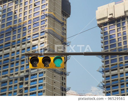 High-rise apartment building under construction and traffic lights High-rise apartment building under construction and traffic lights 96529561