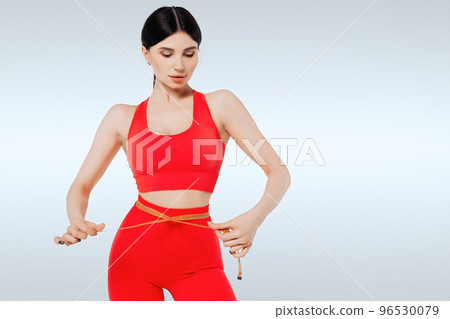 Concept of healthy eating. Fitness woman measuring waist 96530079