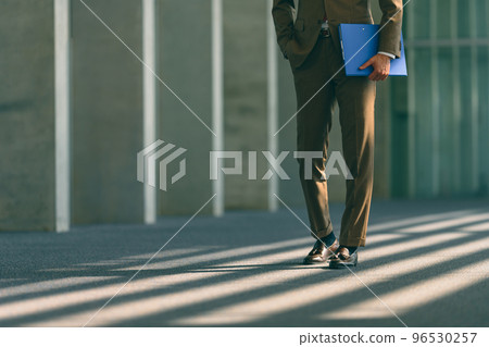 Cool businessman in his 30s-40s wearing a suit Cool businessman in his 30s-40s wearing a suit 96530257