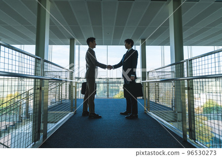 Two businessmen shaking hands Two businessmen shaking hands 96530273