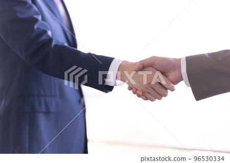 Two businessmen shaking hands Two businessmen shaking hands 96530334