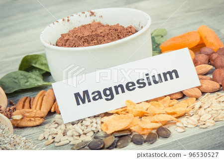 Inscription magnesium with healthy food containing natural magnesium Inscription magnesium with healthy food containing natural magnesium 96530527