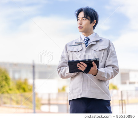 A man in his thirties wearing work clothes A man in his thirties wearing work clothes 96530890