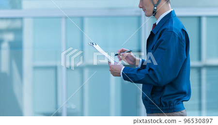 A man in his thirties wearing work clothes A man in his thirties wearing work clothes 96530897