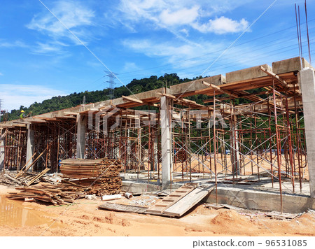 MELAKA, MALAYSIA - MARCH 4, 2021: The building structure is made of reinforced concrete still under construction. This reinforced concrete mold is made of timber and plywood formwork. MELAKA, MALAYSIA - MARCH 4, 2021: The building structure is made of reinforced concrete still under construction. This reinforced concrete mold is made of timber and plywood formwork. 96531085