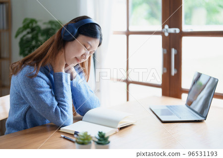 Portrait of young woman showing fatigue from studying online at home. Portrait of young woman showing fatigue from studying online at home. 96531193