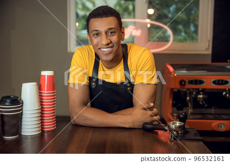 Cheerful bartender posing for the camera in the workplace 96532161