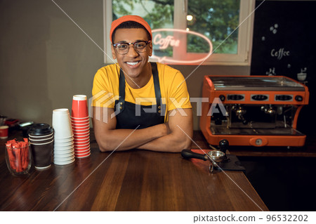 Smiling young coffee worker in his workplace 96532202