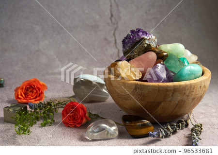 various gem stones in a wooden bowl various gem stones in a wooden bowl 96533681