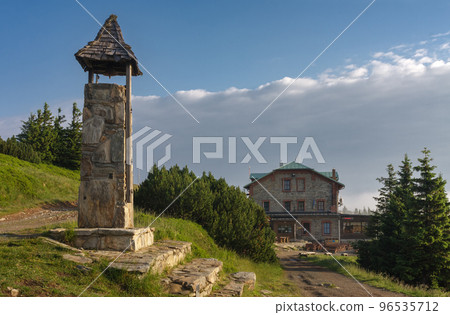 Stone bell tower and old stone mountain  cottage ( Serak) in Jeseniky mountains on a summer foggy morning 96535712