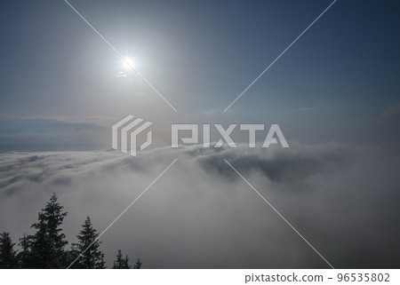 View from  Serak in Jeseniky mountains on a summer foggy morning and  sea of clouds around mountain peak 96535802