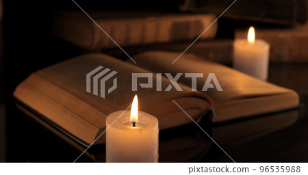An old book and burning candles An old book and burning candles 96535988