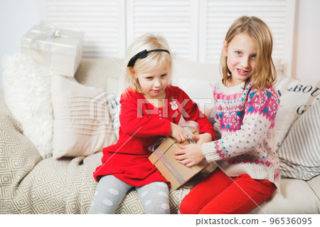 Magic gift box and a child baby girls, Christmas miracle, little beautiful happy smiling girl opens a box with gifts 96536095