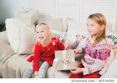 Magic gift box and a child baby girls, Christmas miracle, little beautiful happy smiling girl opens a box with gifts Magic gift box and a child baby girls, Christmas miracle, little beautiful happy smiling girl opens a box with gifts 96536099