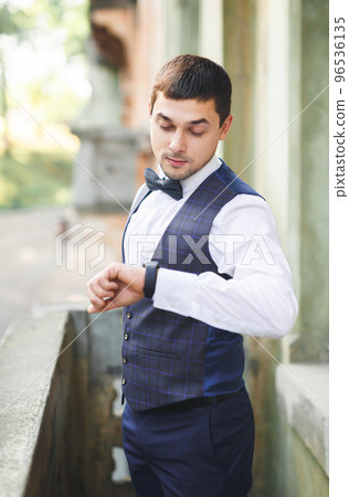 Beautiful man, groom posing and preparing for wedding Beautiful man, groom posing and preparing for wedding 96536135