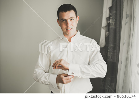 Young handsome man relaxing at his apartment in a hotel after business meeting 96536174